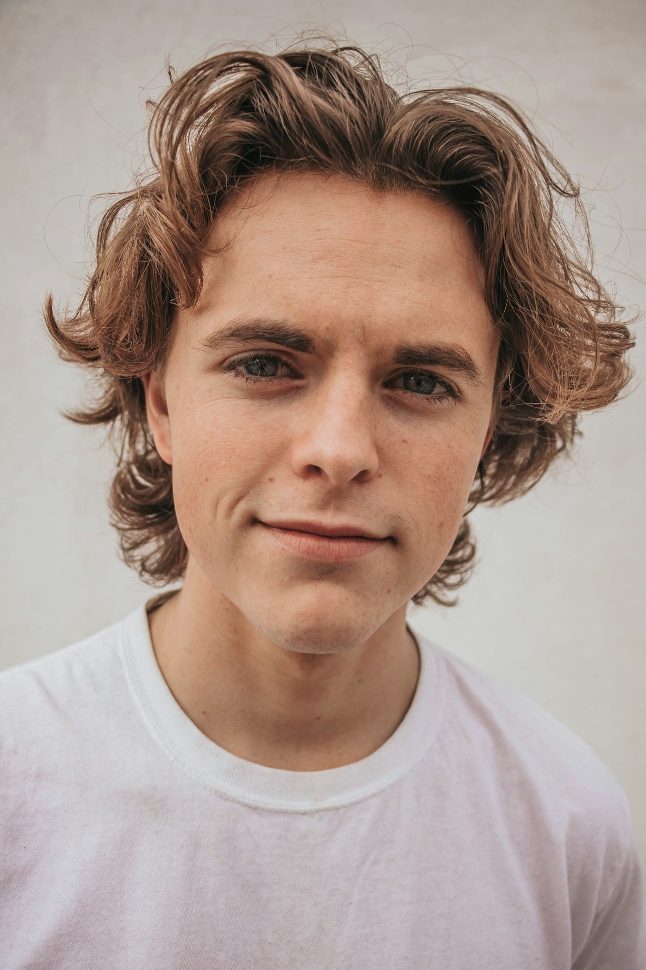 Person with wavy hair, casual shirt.